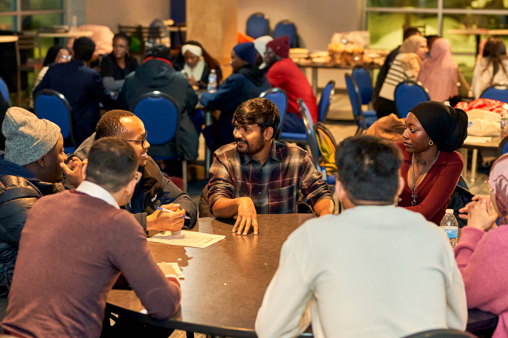international studetns gathered around a table at an event